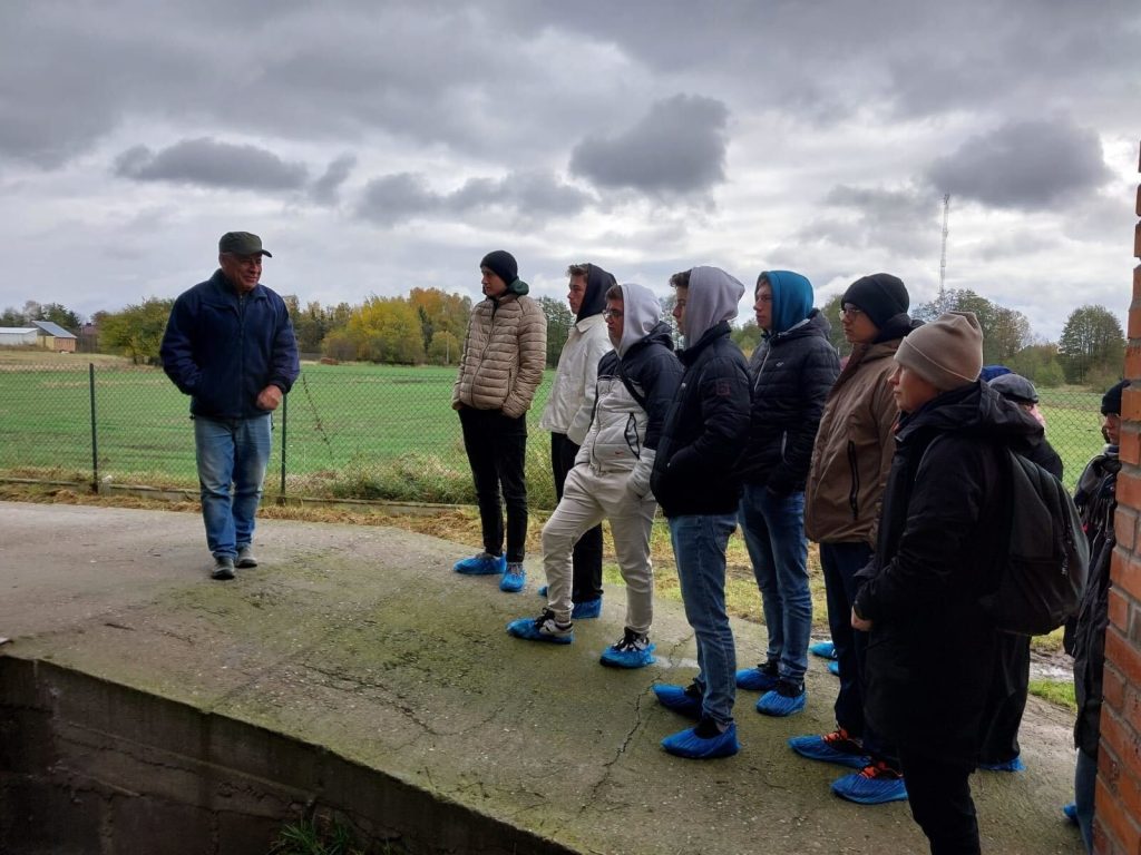 grupa studentów w kurtkach na polu